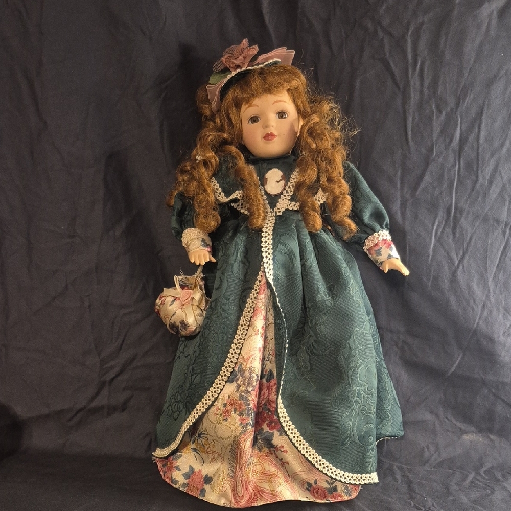 Vintage-Style Green Porcelain Doll with Floral Dress